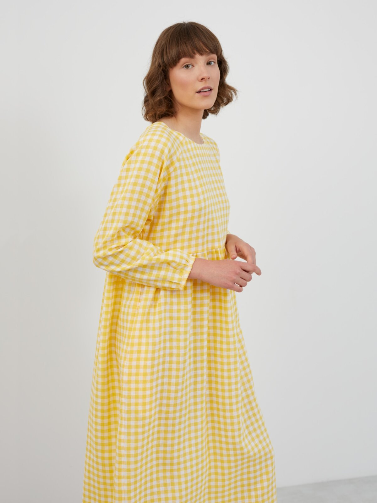 Front view of the BAY long sleeve empire waist linen midi dress in Gingham Yellow