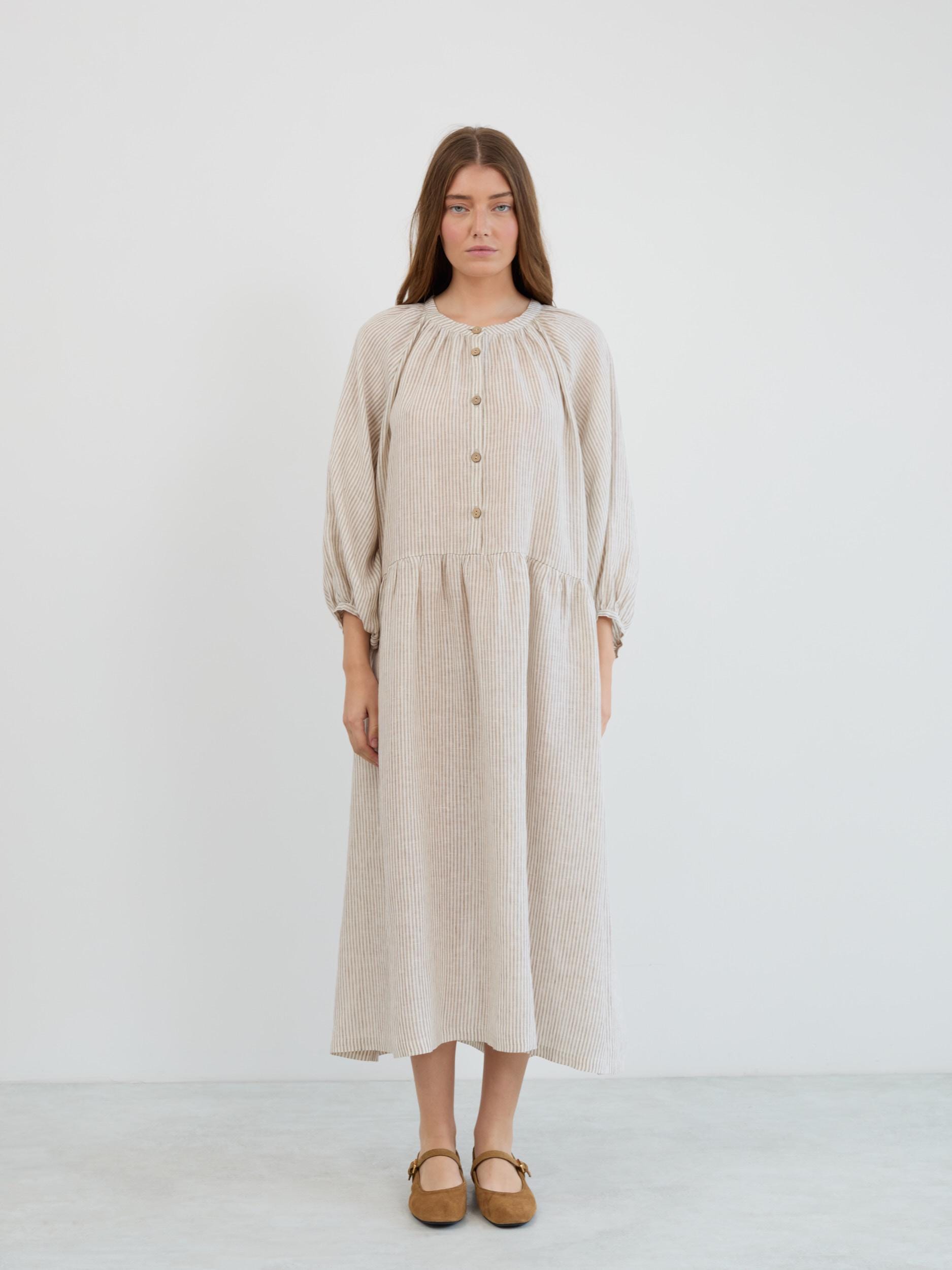 Full-length front view of the Etta boho linen maxi dress showing the loose relaxed fit, dropped waist, and gathered skirt in beige and white stripes