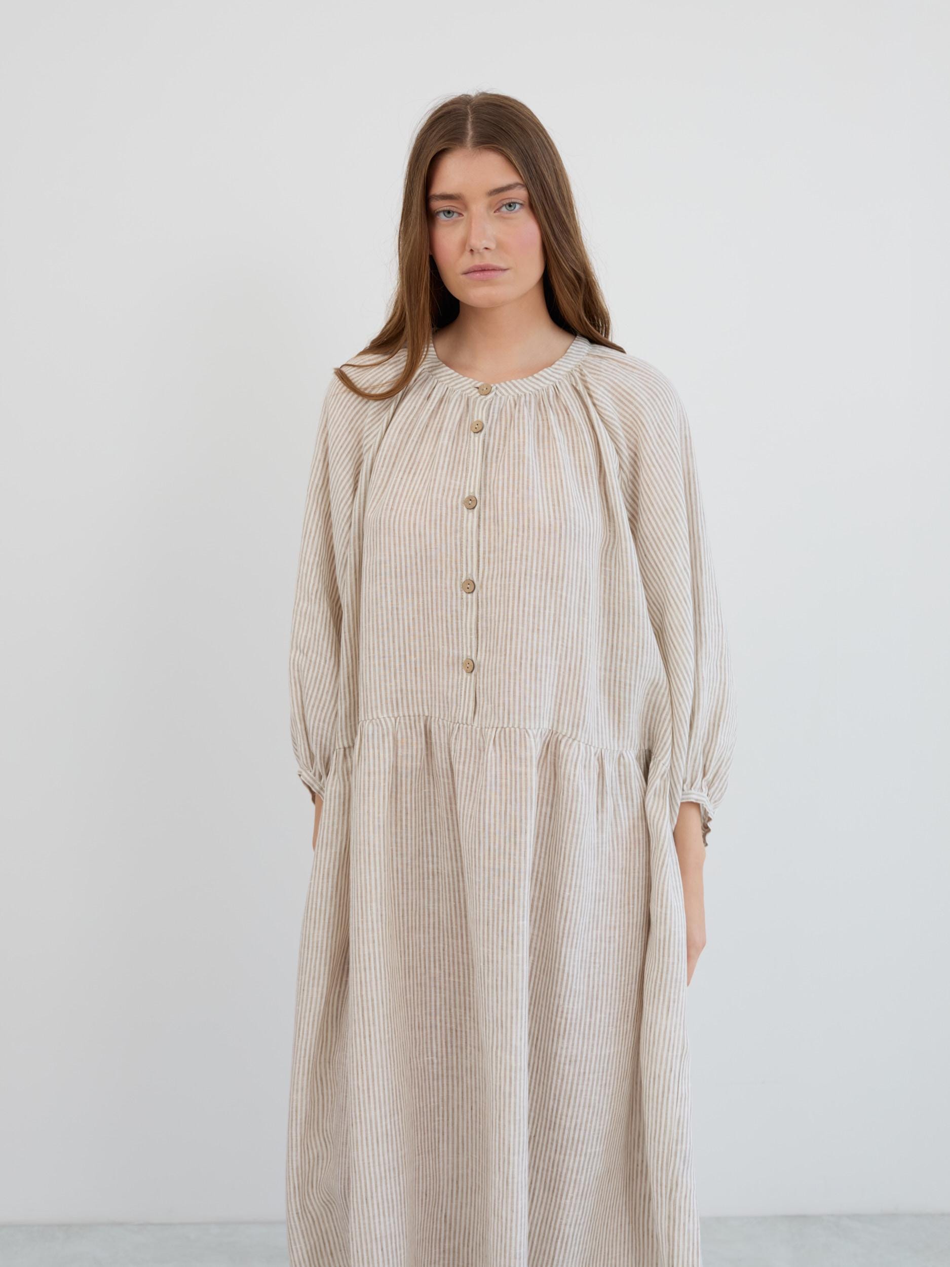 Upper body view of the Etta linen dress showing the gathered round neckline, button placket, and 3/4 balloon sleeves with elastic cuffs in beige and white stripes