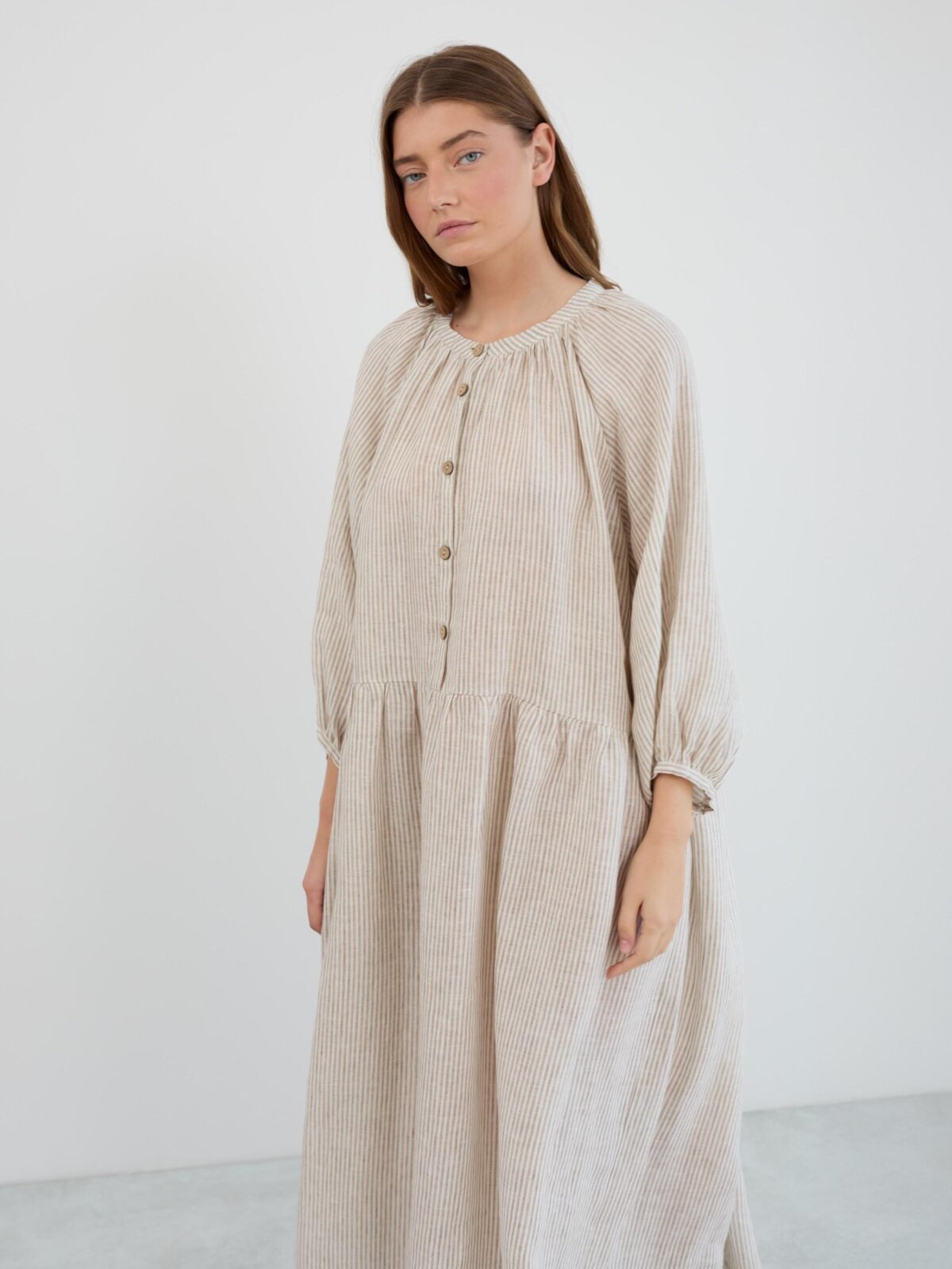 Front three-quarter view of the Etta linen maxi dress showing the dropped waist, gathered skirt, and cuffed 3/4 balloon sleeves