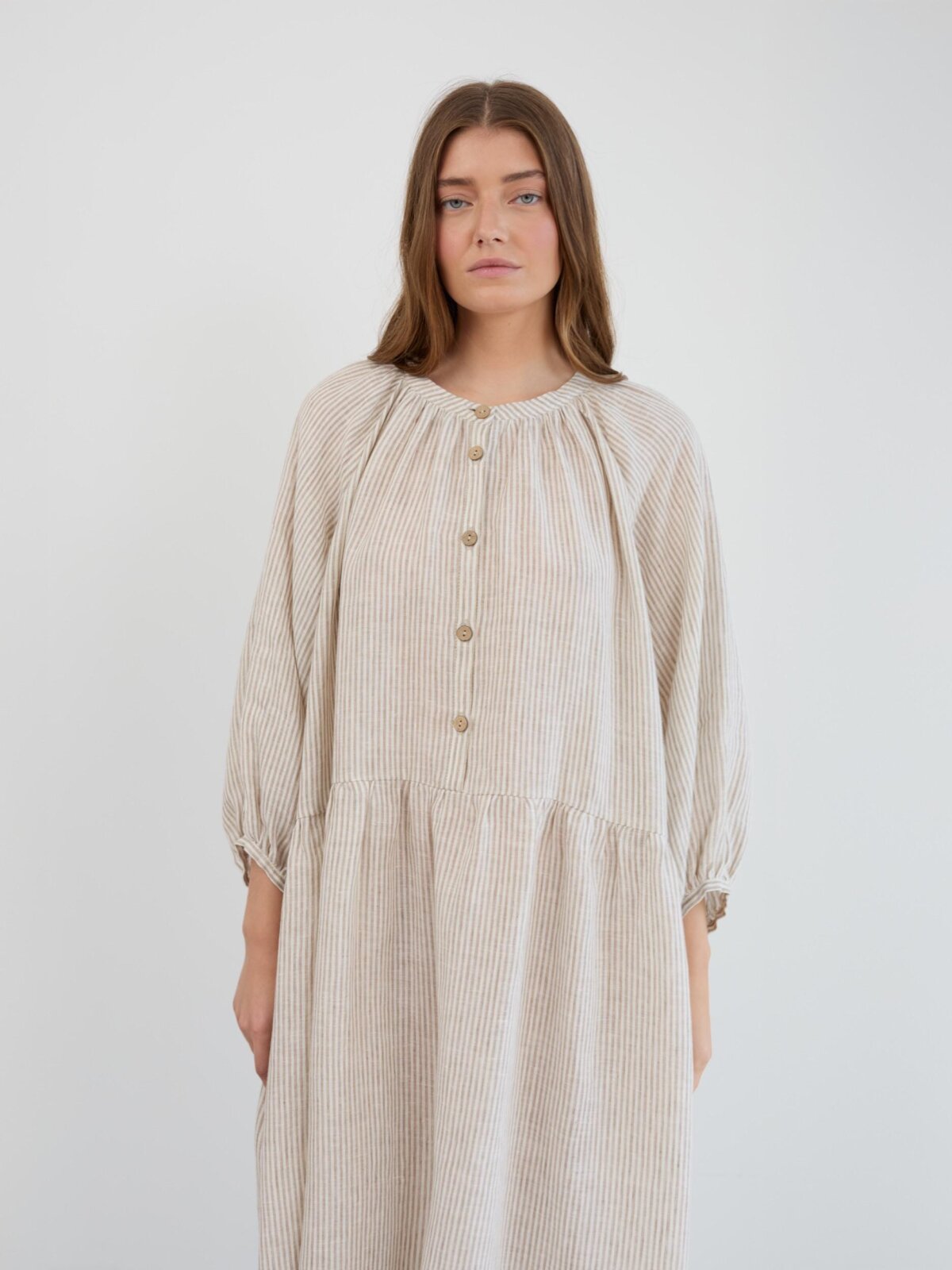 Front detail of the Etta linen dress showing the fine stripe pattern, gathered neckline, and button-down front