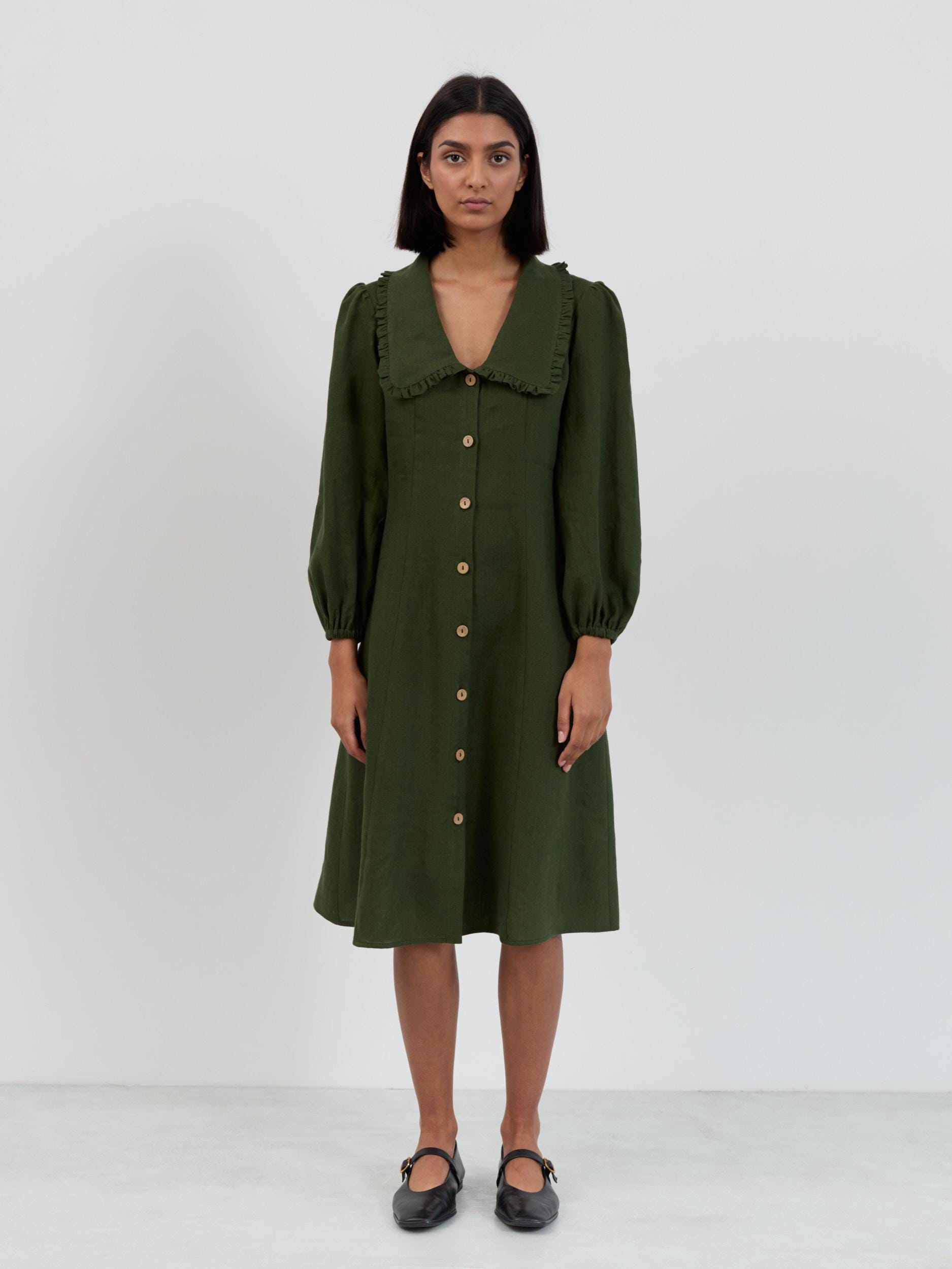 Close-up of the Aubrey linen dress ruffled collar detail and natural wood buttons in forest green