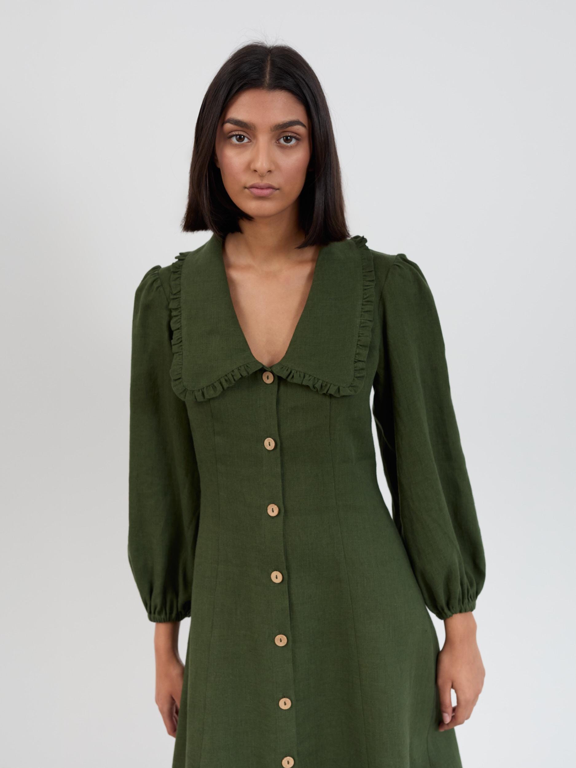 Side view of the Aubrey linen midi dress in forest green showing A-line skirt silhouette