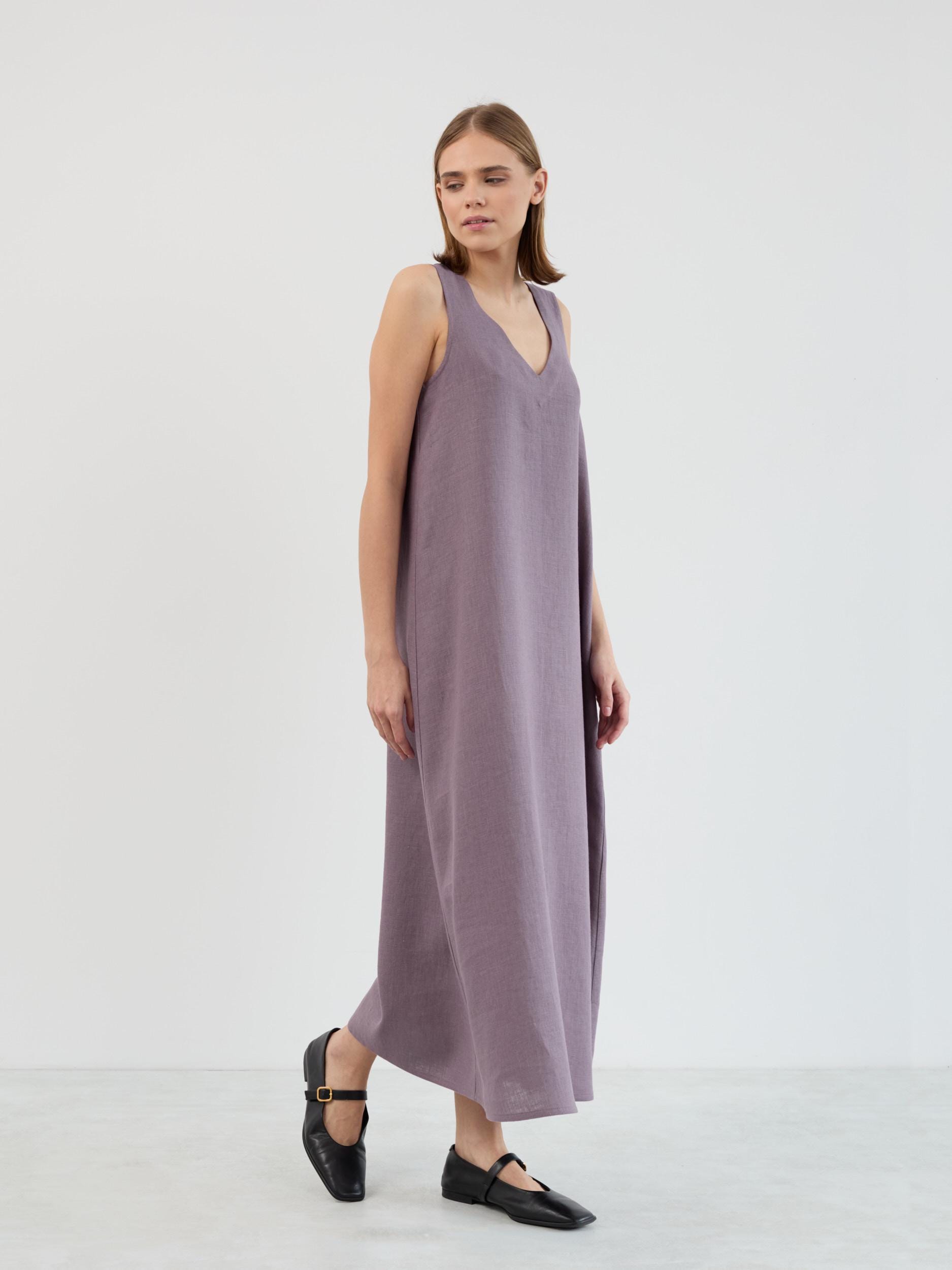 Lanav sleeveless linen maxi dress in lavender violet, three-quarter walking view showing how the A-line shape moves with the body