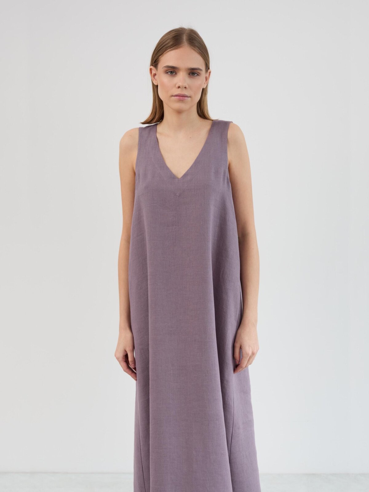 Close-up of the Lanav dress V neckline and wide shoulder straps in lavender violet washed linen, showing the fabric weave and texture