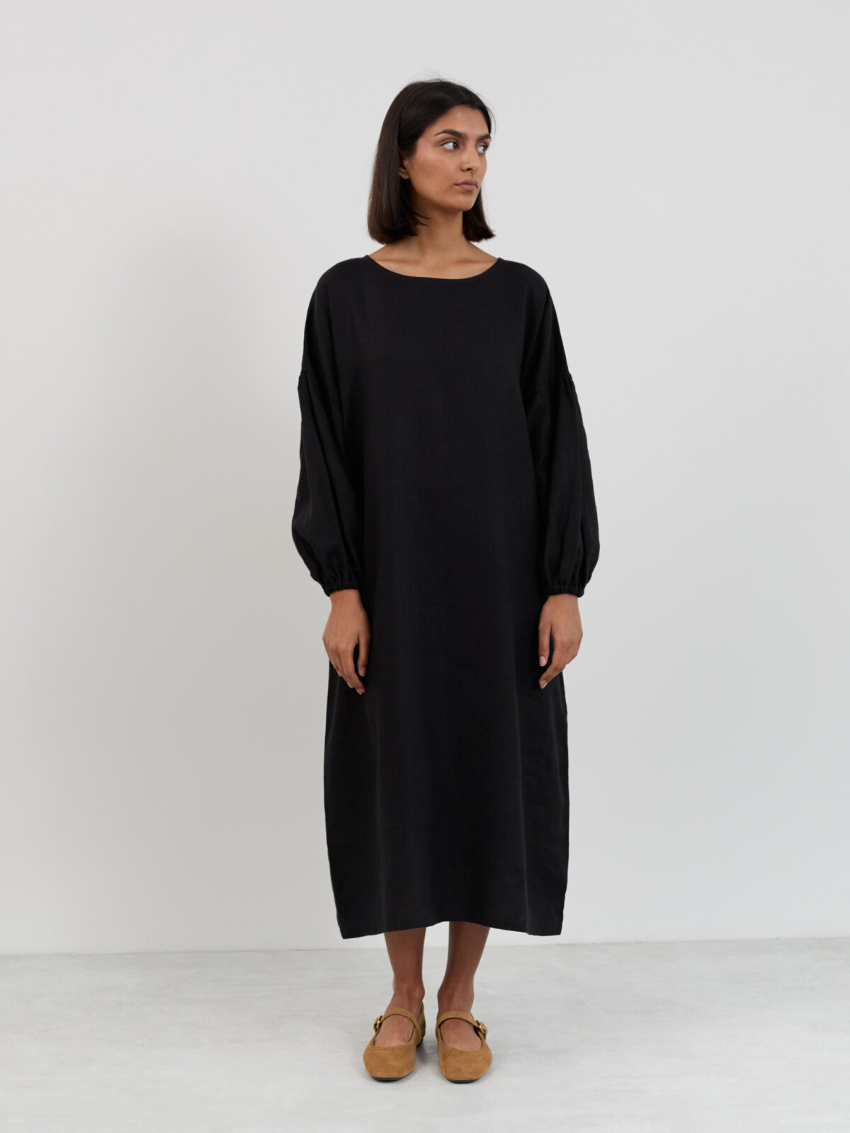 Full front view of the Briar linen midi dress in black showing the straight oversized cut from neckline to mid-calf hem