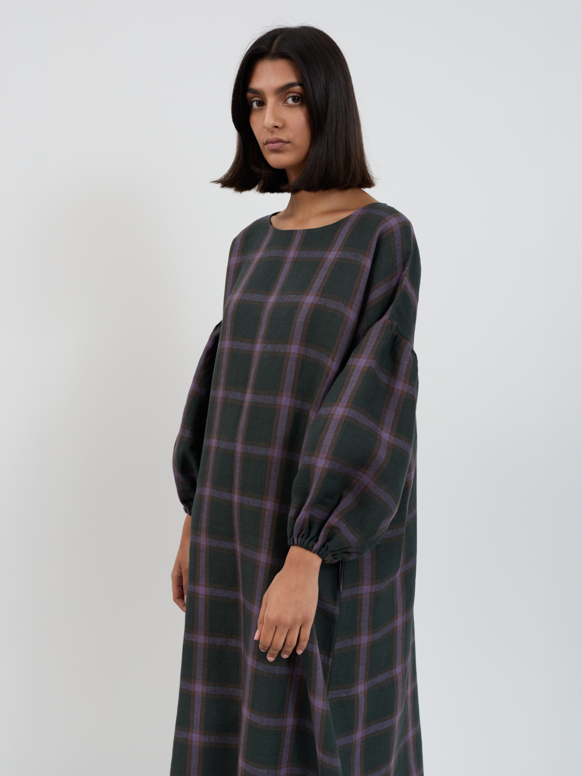 Cropped three-quarter view of the BRIAR Purple Plaid dress showing the boat neckline and balloon sleeves