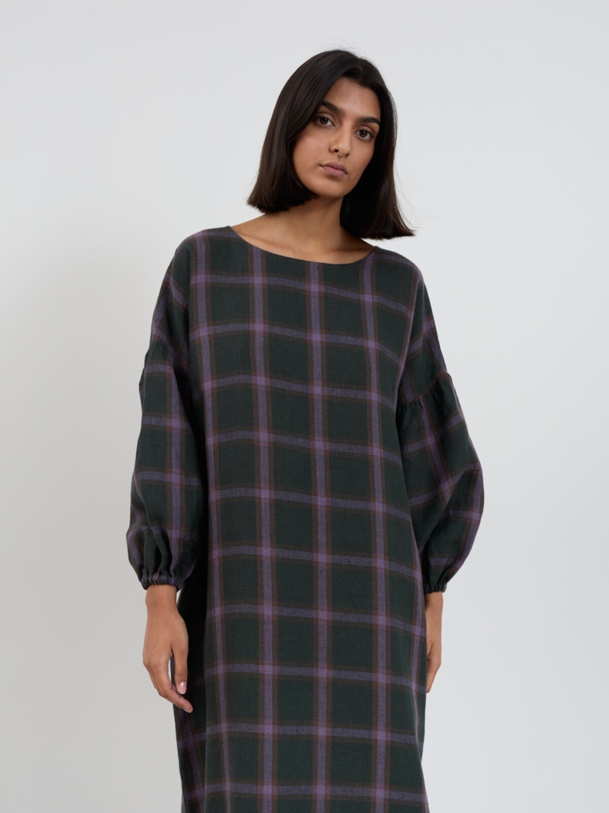 Cropped front view of the BRIAR dress showing the boat neckline, plaid linen and balloon sleeves