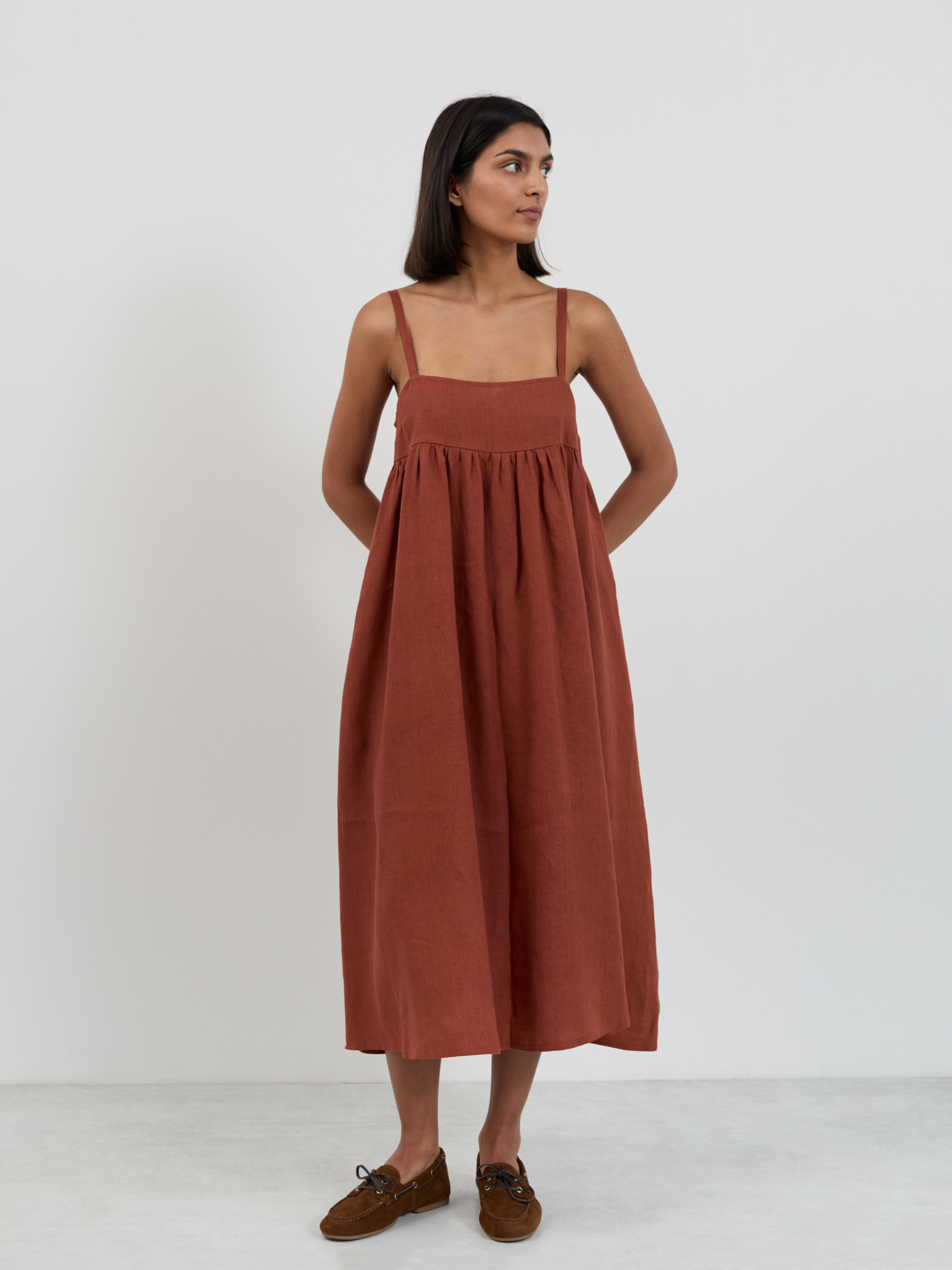 Linen midi sundress with side pockets, relaxed A-line silhouette, front view