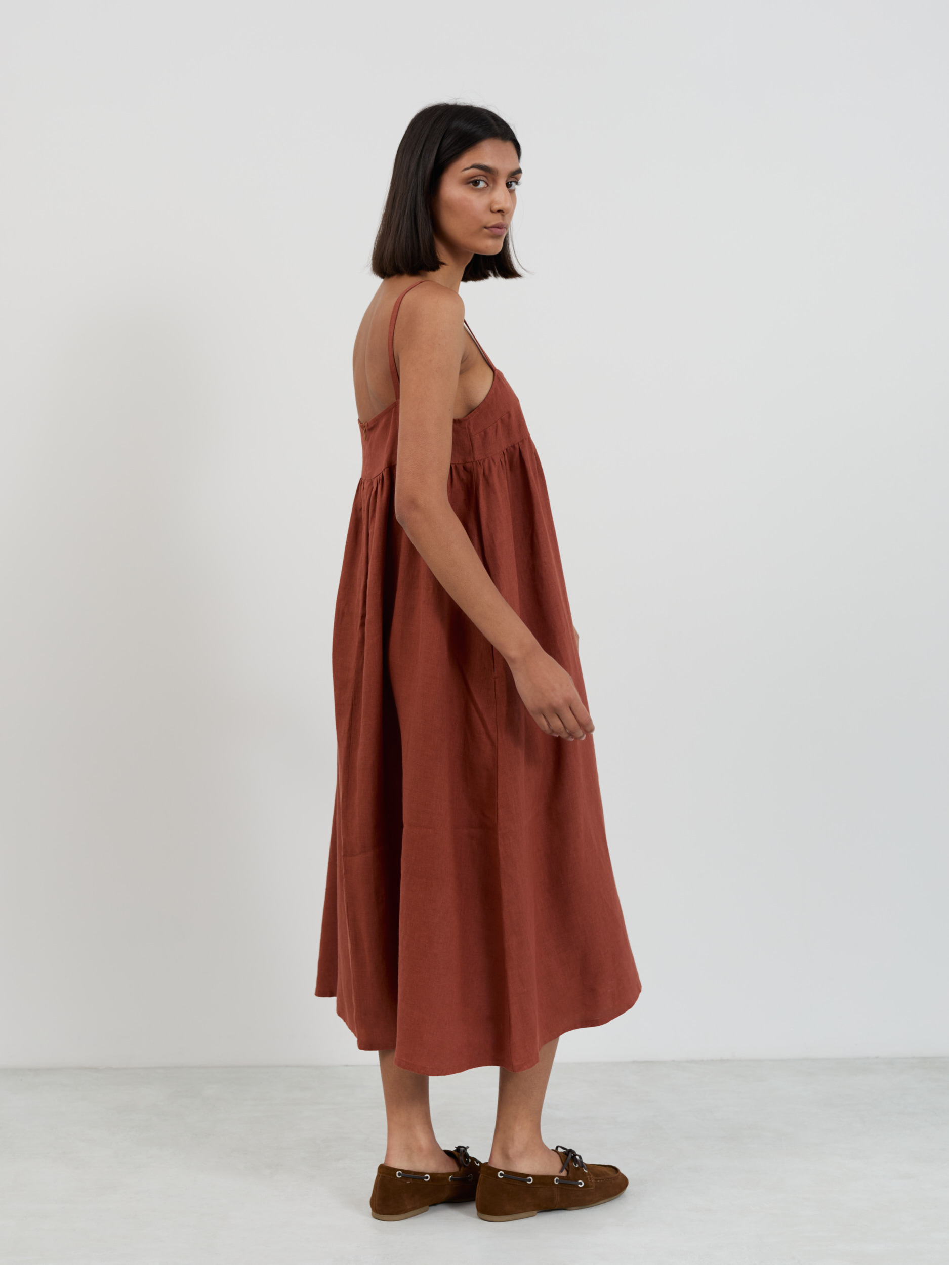 Back view of linen midi sundress showing clean back bodice and full gathered skirt